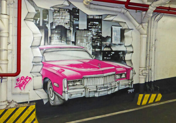 Graff d'une voiture rose dans parking des Champs Elysées à Paris